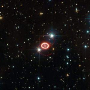 Supernova SN 1987A, one of the brightest stellar explosions since the invention of the telescope more than 400 years ago, is no stranger to the NASA/ESA Hubble Space Telescope. The observatory has been on the frontline of studies into this brilliant dying star since its launch in 1990, three years after the supernova exploded on 23 February 1987. This image of Hubble’s old friend, retreived from the telescope’s data archive, may be the best ever of this object, and reminds us of the many mysteries still surrounding it. Dominating this picture are two glowing loops of stellar material and a very bright ring surrounding the dying star at the centre of the frame. Although Hubble has provided important clues on the nature of these structures, their origin is still largely unknown. Another mystery is that of the missing neutron star. The violent death of a high-mass star, such as SN 1987A, leaves behind a stellar remnant — a neutron star or a black hole. Astronomers expect to find a neutron star in the remnants of this supernova, but they have not yet been able to peer through the dense dust to confirm it is there. The supernova belongs to the Large Magellanic Cloud, a nearby galaxy about 168 000 light-years away. Even though the stellar explosion took place around 166 000 BC, its light arrived here less than 25 years ago. This picture is based on observations done with the High Resolution Channel of Hubble’s Advanced Camera for Surveys. The field of view is approximately 25 by 25 arcseconds.